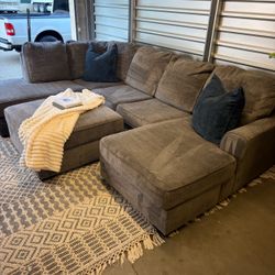Can deliver - Gray Ashley U-Shaped Sectional + Storage Ottoman