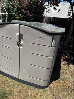 Rubbermaid Slide-Lid outdoor storage shed, typically used for storing lawn equipment and bicycles.
