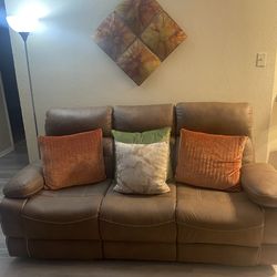 Brown reclining living room set – sofa, loveseat, and chair.