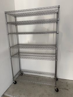 2 heavy duty metal shelving units on wheels