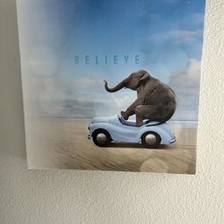 Elephant driving car 'Believe' canvas art