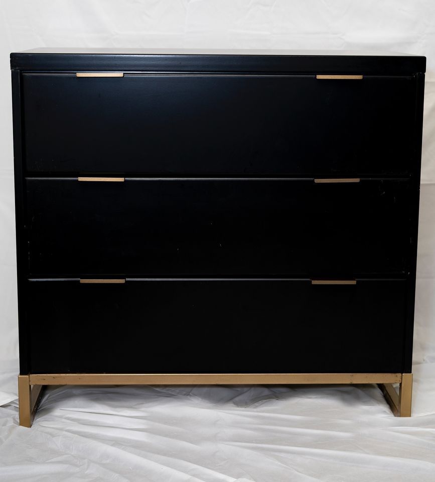 Black dresser with gold accents