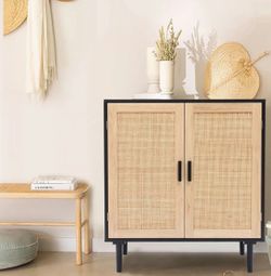 This 2-door rattan storage cabinet blends modern lines with natural texture for a warm, organic look. Featuring black and brown wood tones with woven 