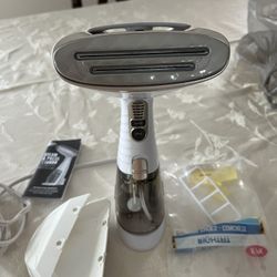 New steam iron with its instruction manual