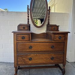 Antique tiger oak vanity / dresser with a swivel mirror, featuring barley twist columns and legs