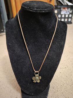 Dark brown necklace with bronze flower