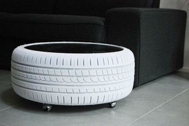 Lounge tire table with glass on top and light inside