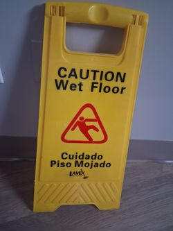 Bright yellow caution wet floor sign