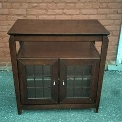 Wooden household shelf and stand unit with enclosure cubby and glass doors