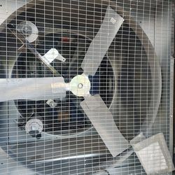 Large industrial exhaust fan with protective grid. $240 each Located Mount Dora Fla 32757