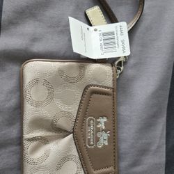 Coach wristlet in original packaging.