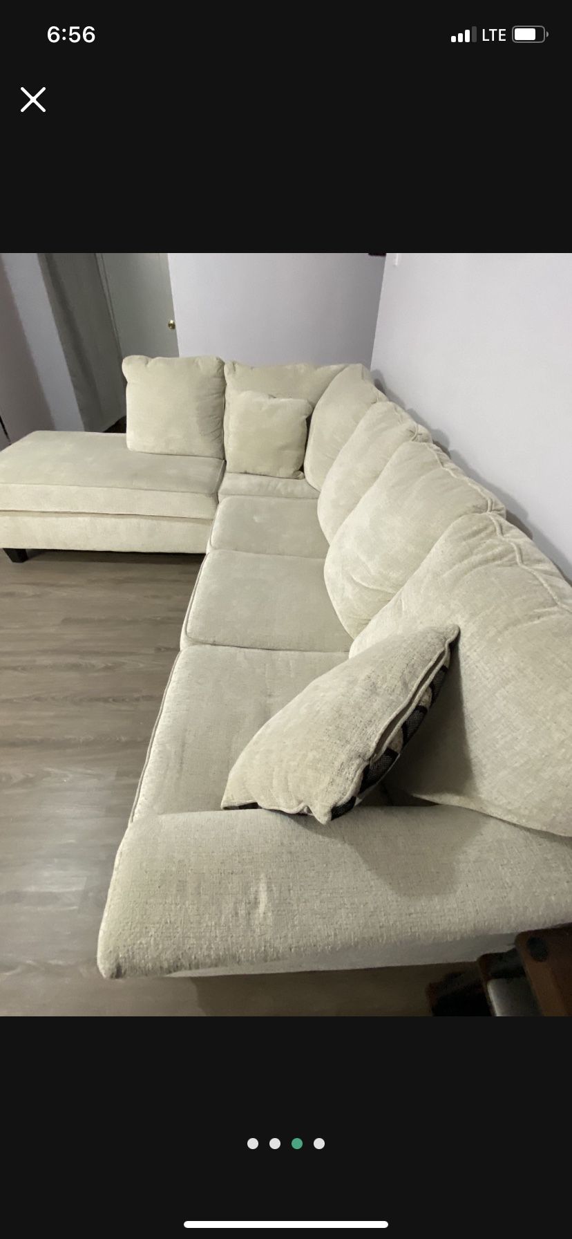 beige L-shaped couch with 2 accent pillows 