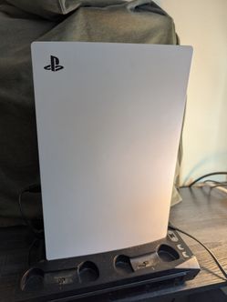 Sony PlayStation 5 with cooling station and controller pickup only.