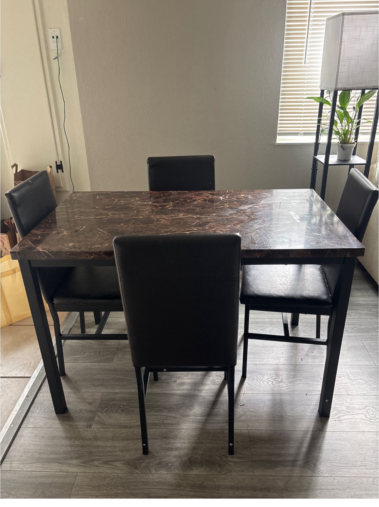 Brown Marble Table With Brown Leather Chairs  