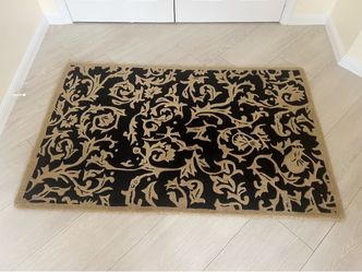 Handmade Rug 65” X 41”. Well made rug in beige and black. Perfect condition No smoke or pets