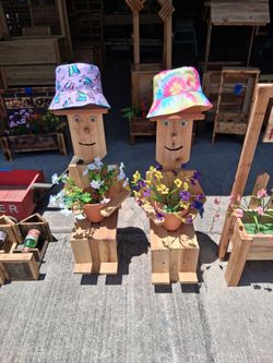 Planters boy 36 inches high $50 each  with artificial flowers