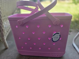Brand new bogg bag with heart shaped holes with tags on it