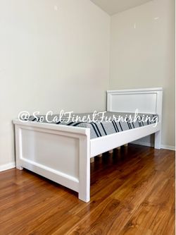 White twin bed and mattress