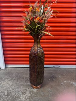 Tall metal vase with decor