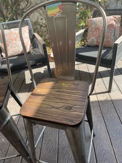 Pair of metal bar stools with wood seats