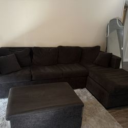 L shaped dark gray sofa with ottoman