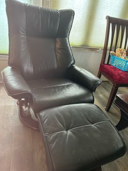 Black leather recliner with footstool that opens