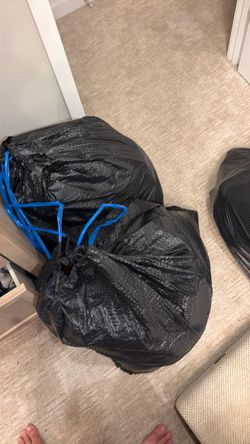 Two bags men’s clothes and a bag of hangers