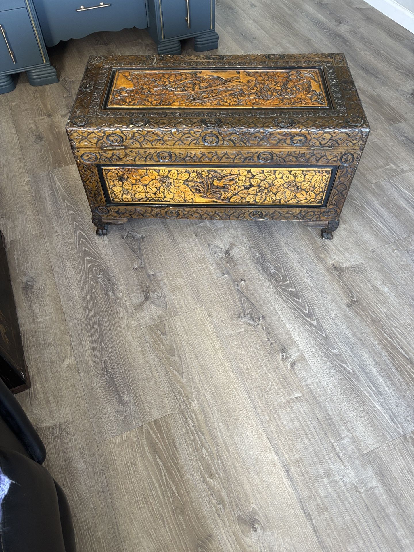 Antique Chinese carved camphor wood chest with floral and bird motifs.