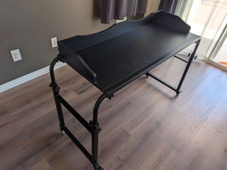 Adjustable overbed table with wheels