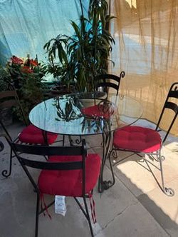 Patio table with 4 chairs iron, glass with cushion red