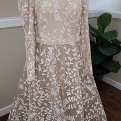 An elegant beige dress designed specifically for veiled women, combining elegance and modesty.
