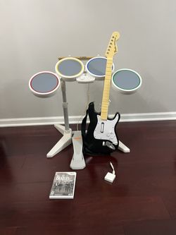 Nintendo Wii Rock band ( wired drums, guitar, dongel, sticks, pedal and game)
