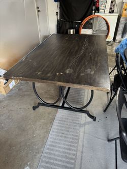 Brown wood rectangular dining table with metal legs