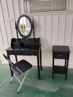 Black vanity with black side table.
