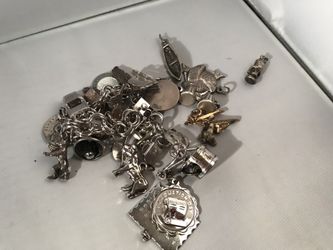 Sterling silver charm bracelet with many extra charms