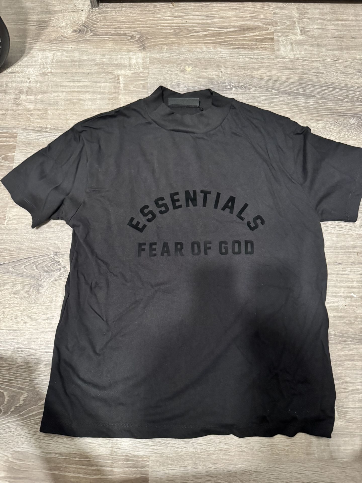 Selling authentic Fear of God Essentials Shirt in black, size Medium