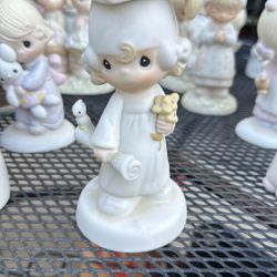 Precious Moments "The Lord Bless You and Keep You" graduation figurine, produced by Enesco in 1980.