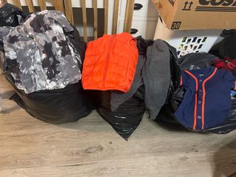 Three big trash bags full of boys clothes 3T, 4T, 5T and some girls an women’s clothes. Small blankets