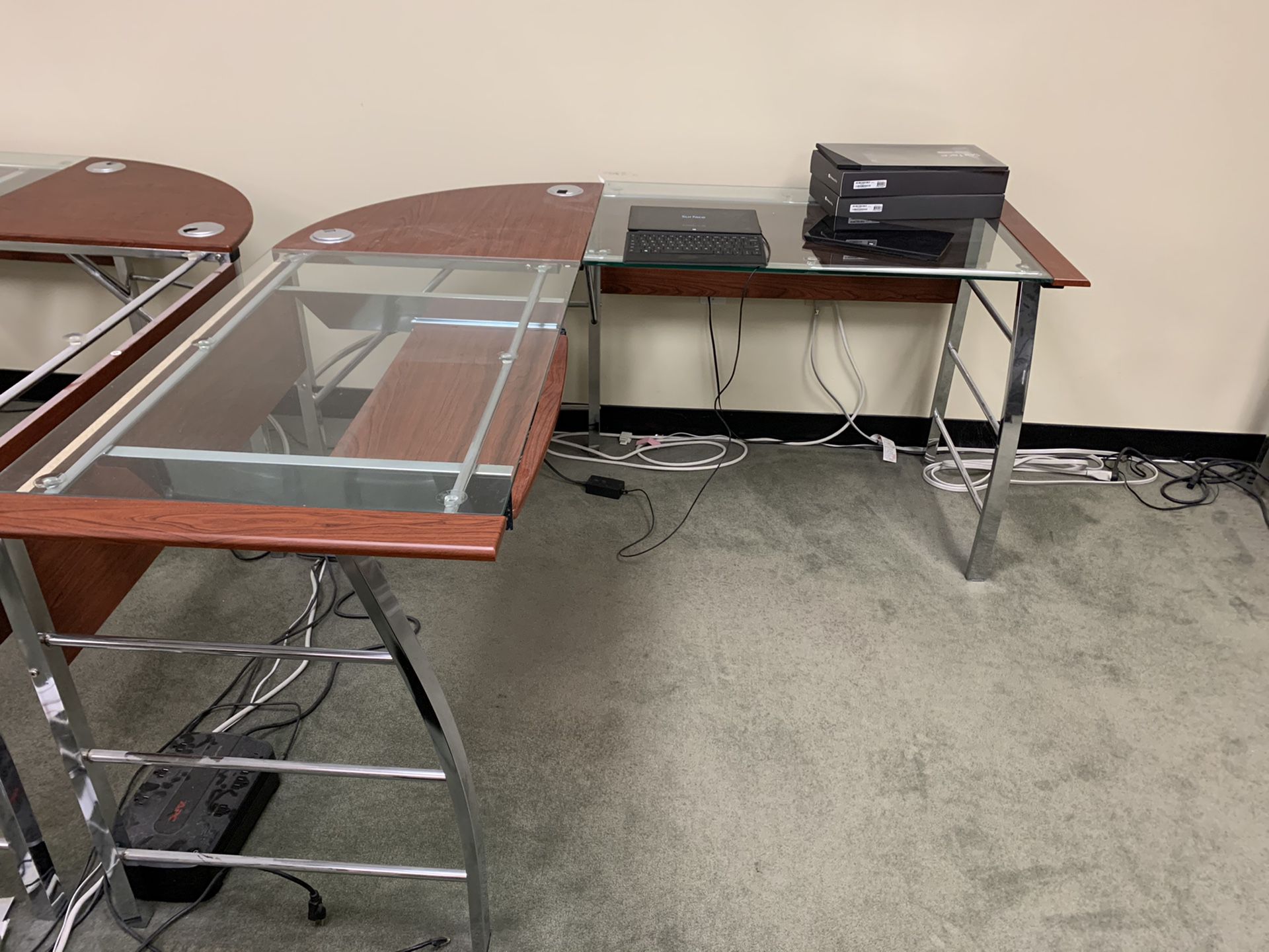 L-shaped glass top office desk with chair