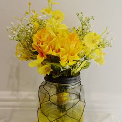 Farmhouse style yellow wire case with flowers and acrylic water
