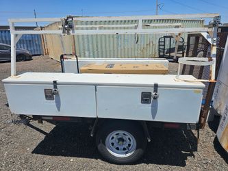 Utility trailer with tool boxes and ramp
