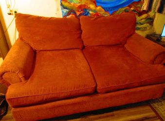 Red loveseat and pillows