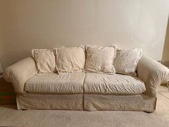 Cream Slipcovered Two-Seat Sofa with Pillows