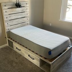 Children's twin bed with mattress, boxspring, lamp, and drawer with posters