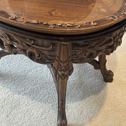 Ornate carved wood table with framed glass top serving tray