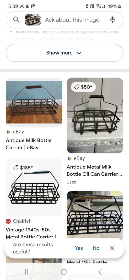 Antique metal milk bottle Carrier with one bottle.