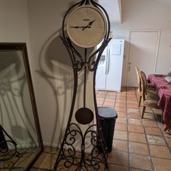 Howard Miller Wrought Iron Grandfather Clock With Stone Face.
