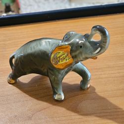 vintage Japanese porcelain elephant figurine adorned with distinct gold accents.