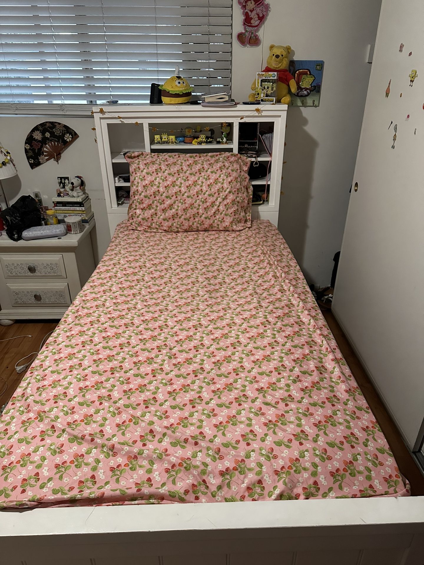 Twin XL bed with storage and bookcase.
