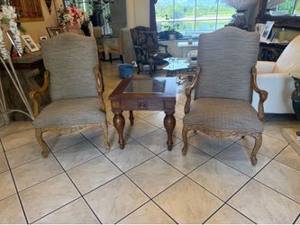set of chairs and end table that are in excellent condition with carved wood frame and upgraded fabric with staying protectant